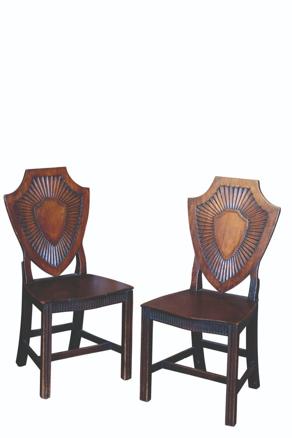 A PAIR OF GEORGE III MAHOGANY HALL CHAIRS