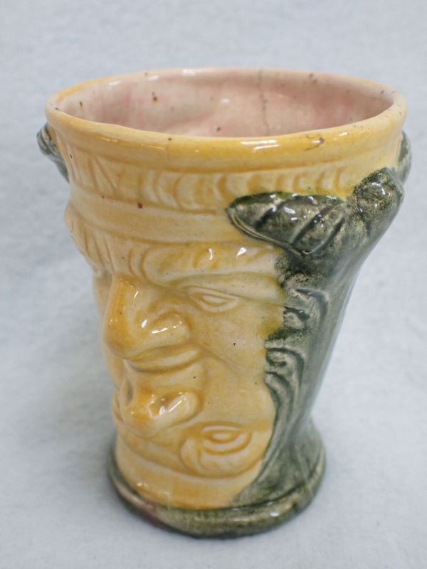 A POTTERY FOUR-HEADED CUP