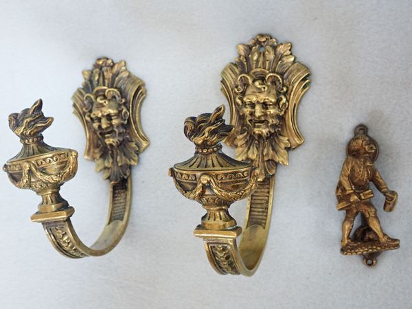 A PAIR OF FRENCH BRASS CURTAIN TIEBACKS