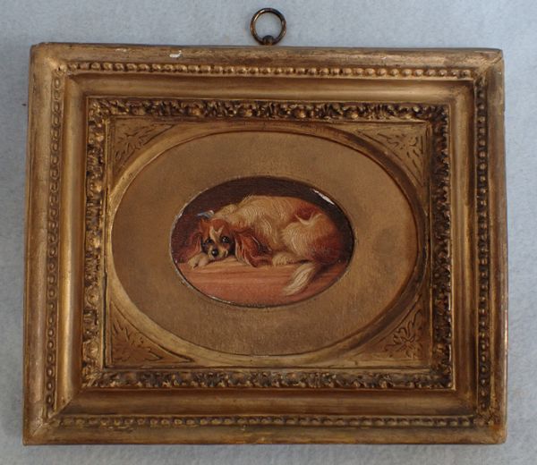 A MINIATURE OIL ON BOARD PAINTING OF A KING CHARLES SPANIEL