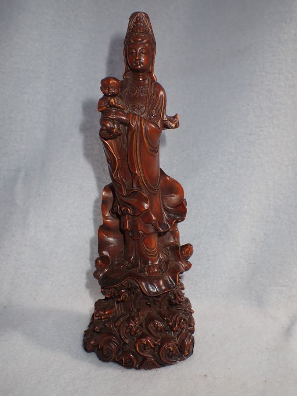 A CARVED CHINESE WOODEN FIGURE OF GUAN YIN