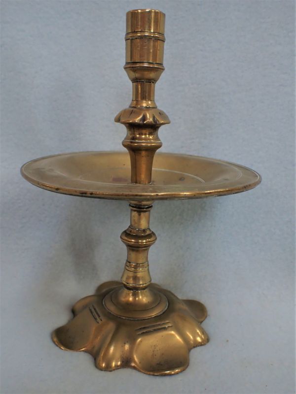 A PETAL FOOT BRASS CANDLESTICK