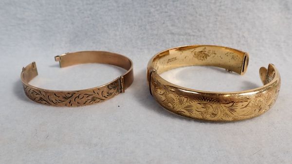 TWO ROLLED GOLD BANGLES