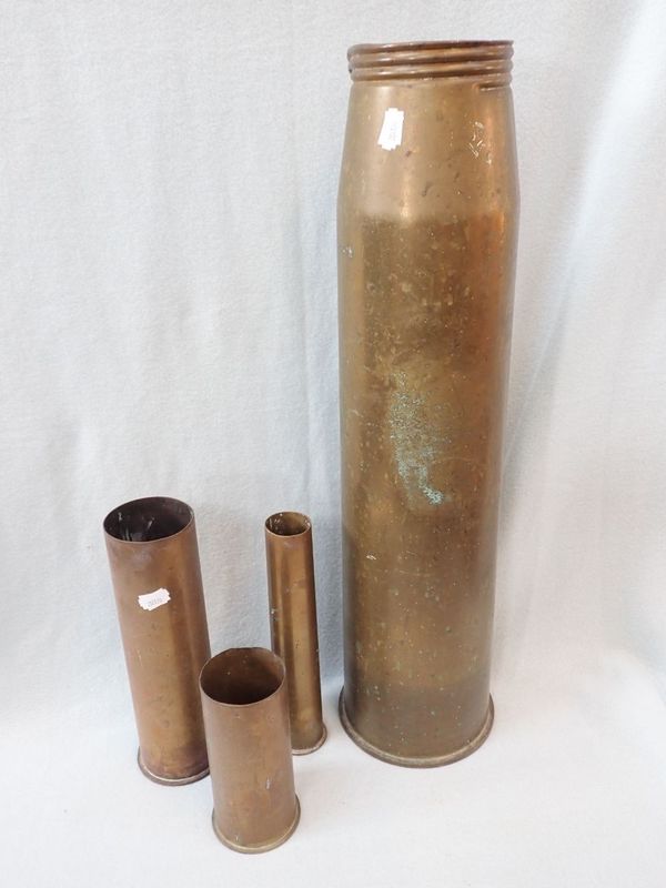 A LARGE BRASS SHELL CASE