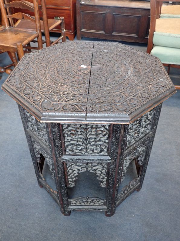 AN INDIAN CARVED HARDWOOD OCTAGONAL TABLE
