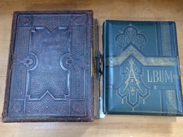 A LEATHER COVERED PHOTOGRAPH ALBUM