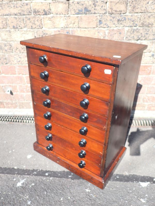 A STAINED PINE COLLECTOR'S CHEST OF DRAWERS