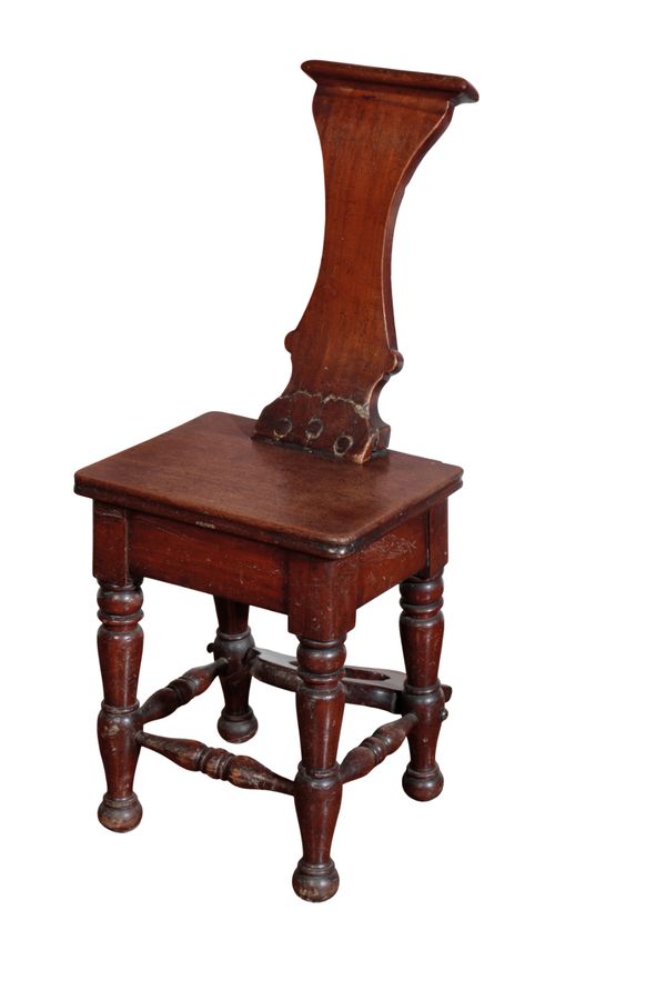 A GEORGE IV MAHOGANY AND WALNUT HALL CHAIR BOOT-PULL,