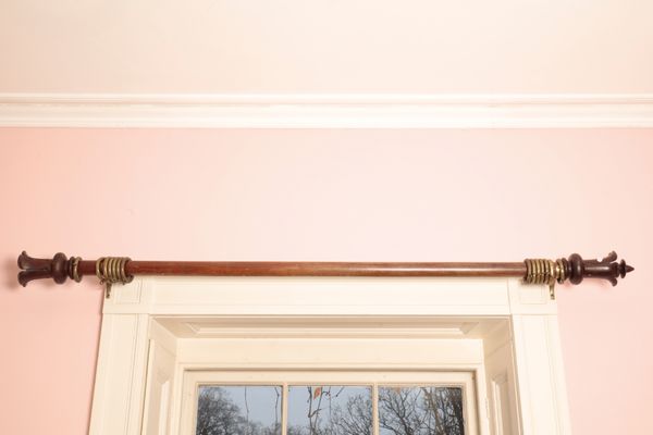 A GEORGE IV MAHOGANY CURTAIN POLE,