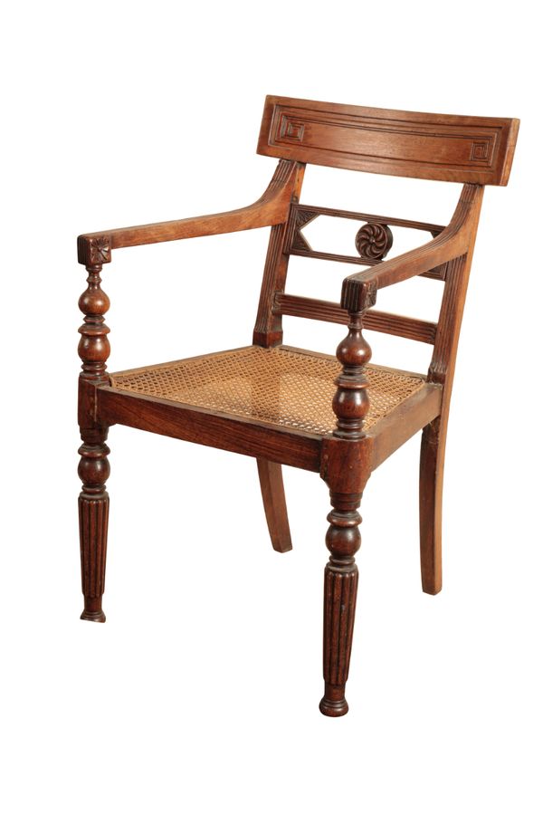 AN ANGLO COLONIAL TEAK LIBRARY ELBOW CHAIR,