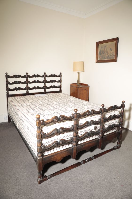 A CARVED WALNUT DOUBLE BED, BY HEAL & SON,