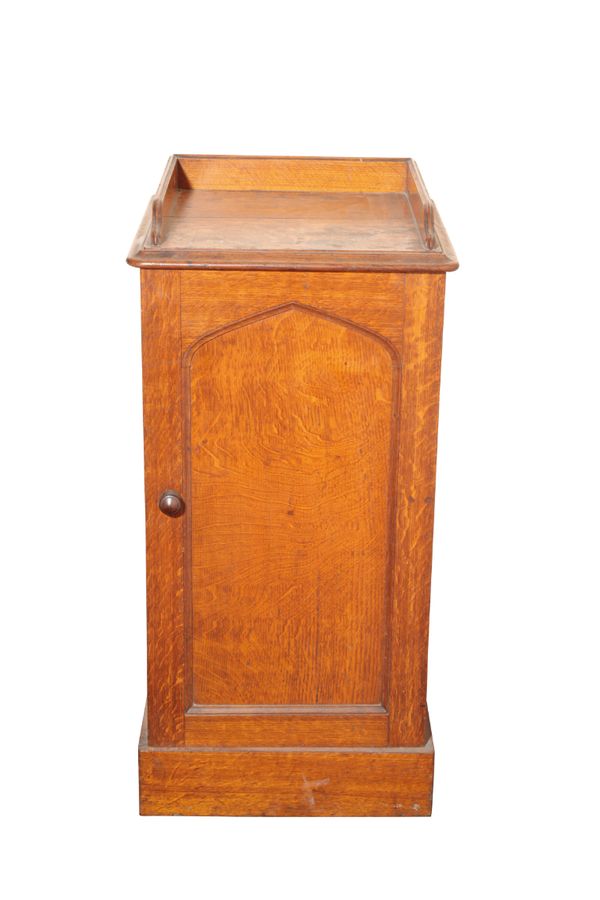 A VICTORIAN OAK BEDSIDE CUPBOARD IN GOTHIC STYLE, POSSIBLY IRISH,