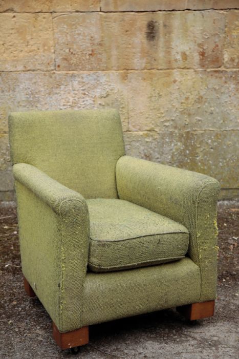 A GREEN UPHOLSTERED ARMCHAIR,