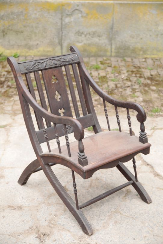 A VICTORIAN OAK AND PINE ELBOW CHAIR IN REFORMED GOTHIC STYLE,