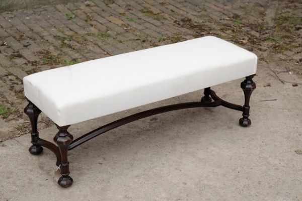 A WALNUT AND UPHOLSTERED LONG STOOL, IN 17TH CENTURY STYLE,