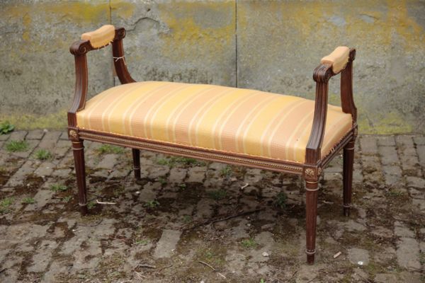 A MAHOGANY AND UPHOLSTERED WINDOW SEAT, IN EMPIRE STYLE,