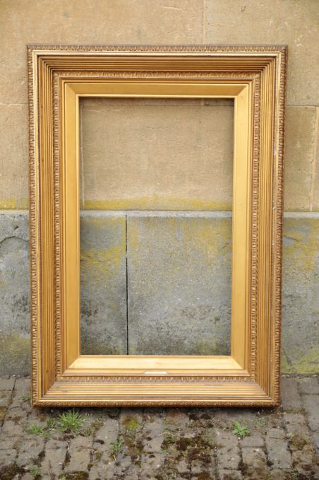 A GILT COMPOSITION PICTURE FRAME IN DIRECTOIRE STYLE,