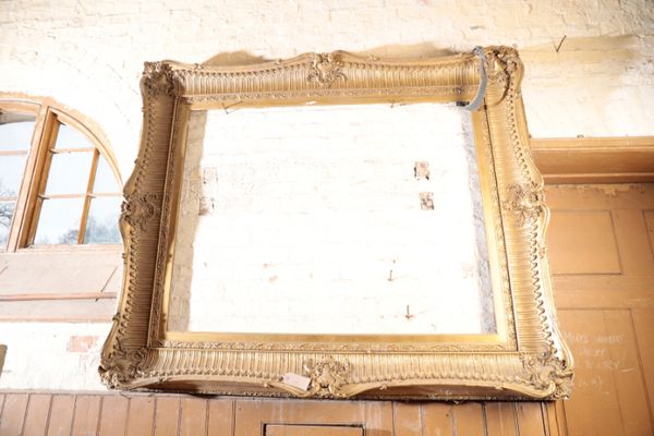 A SUBSTANTIAL GILT COMPOSITION PICTURE FRAME IN REGENCE STYLE,