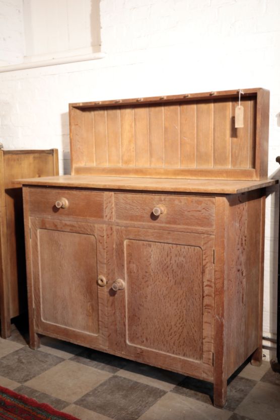 AN OAK KITCHEN SIDEBOARD, IN ARTS AND CRAFTS STYLE, BY HEAL & CO.,