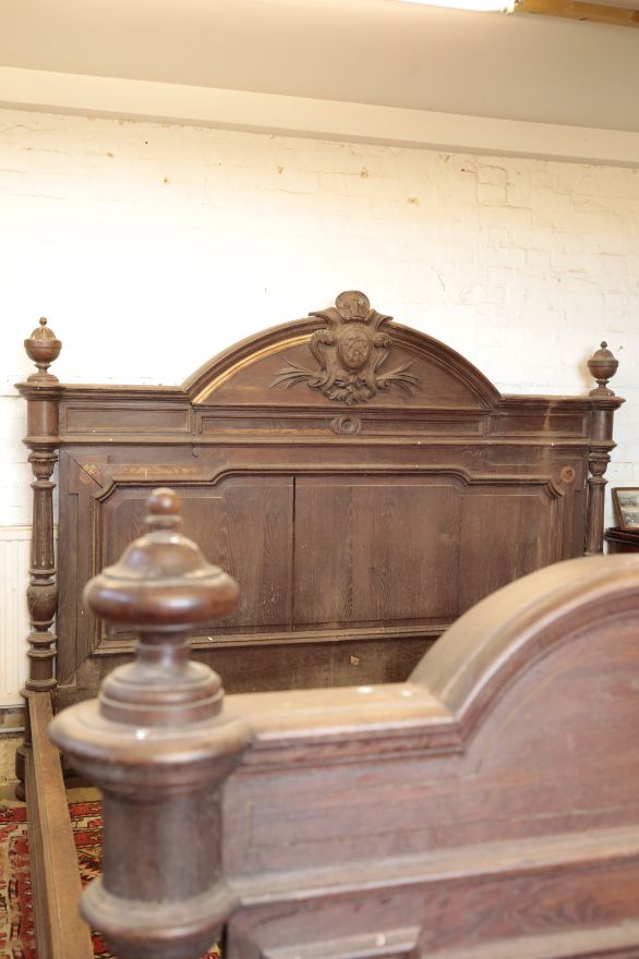 A SUBSTANTIAL CARVED OAK BED,