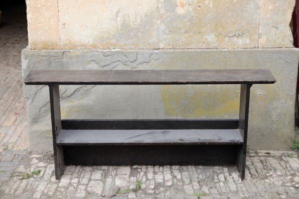 AN EBONISED OAK PLATE RACK IN ARTS AND CRAFTS STYLE, AFTER LIBERTY & CO,