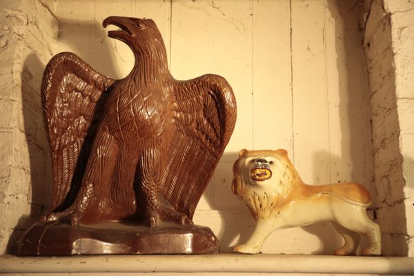 A GLAZED CERAMIC MODEL OF AN EAGLE,