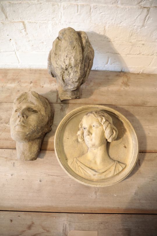 A STONE COMPOSITION MODEL OF THE HEAD OF A WOMAN,