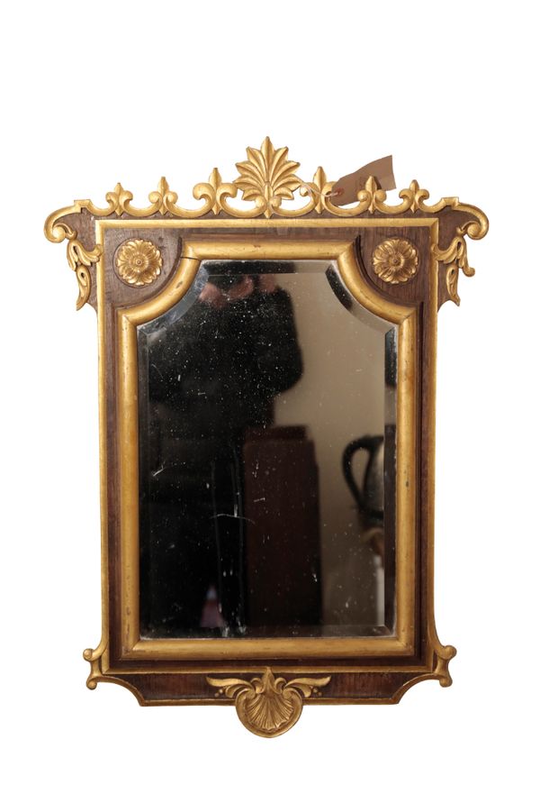 A CONTINENTAL PARCEL GILT WALNUT FRAMED WALL MIRROR,