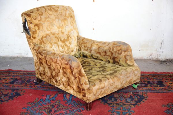 AN UPHOLSTERED ARMCHAIR, BY HOWARD & SONS,