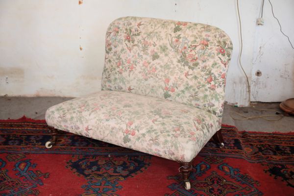 A VICTORIAN MAHOGANY AND UPHOLSTERED TWO SEAT LOW SOFA,