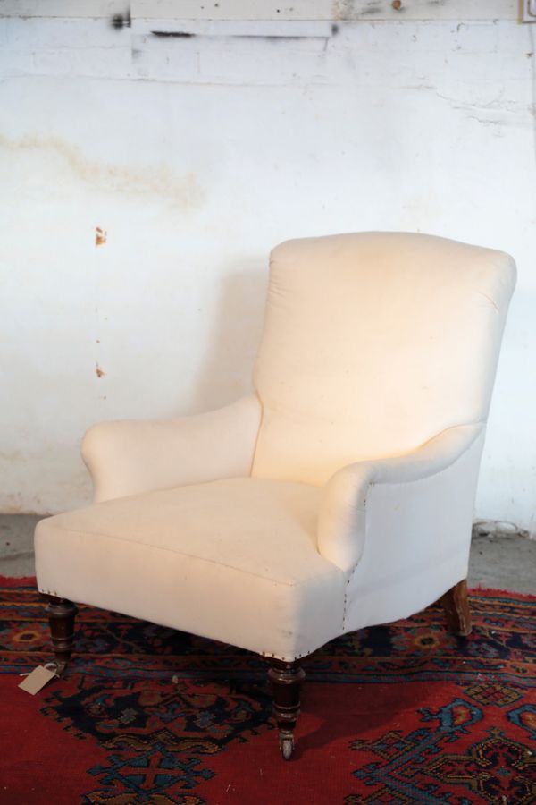 A VICTORIAN UPHOLSTERED ARMCHAIR, IN THE MANNER OF HOWARD AND SONS,