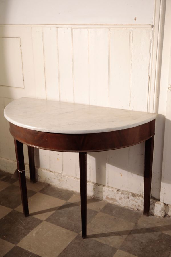 A GEORGE III MAHOGANY AND MARBLE TOPPED DEMI-LUNE TABLE,