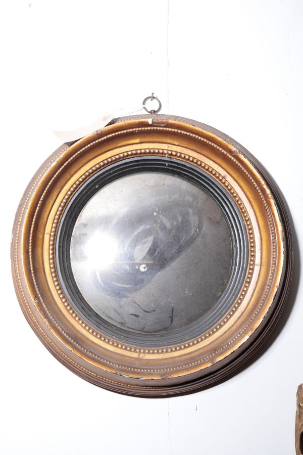 A REGENCY GILTWOOD FRAMED CONVEX WALL MIRROR,