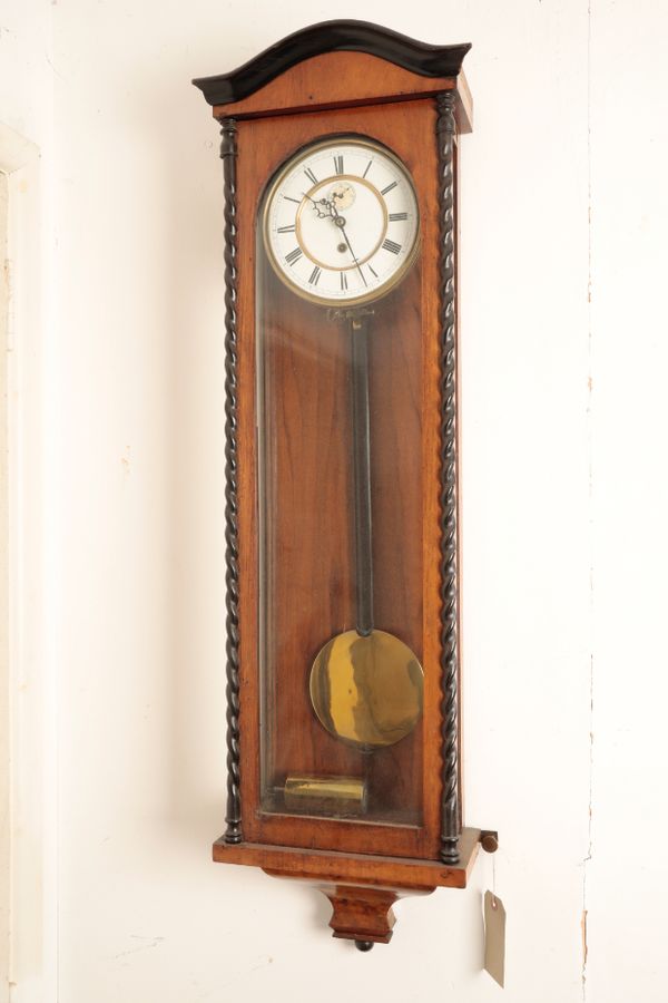 A CONTINTNTAL WALNUT AND EBONISED WALL TIMEPIECE, IN THE MANNER OF A VIENNA REGULATOR,