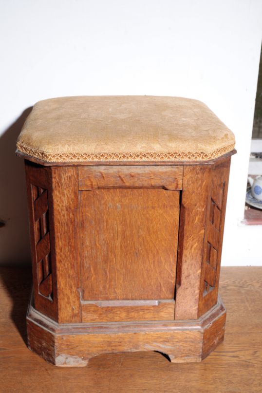 A VICTORIAN OAK AND UPHOLSTERED OTTOMAN STOOL, IN THE MANNER OF HOWARD & SONS,
