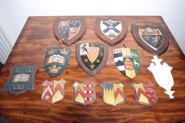 A GROUP OF TWELVE VARIOUS PAINTED PLASTER, WOOD AND METAL ARMORIAL PANELS,