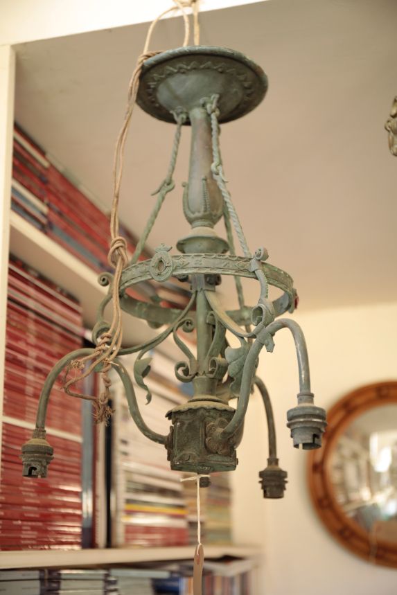 AN EDWARDIAN VERDIGRIS PATINATED METAL THREE LIGHT ELECTROLIER,