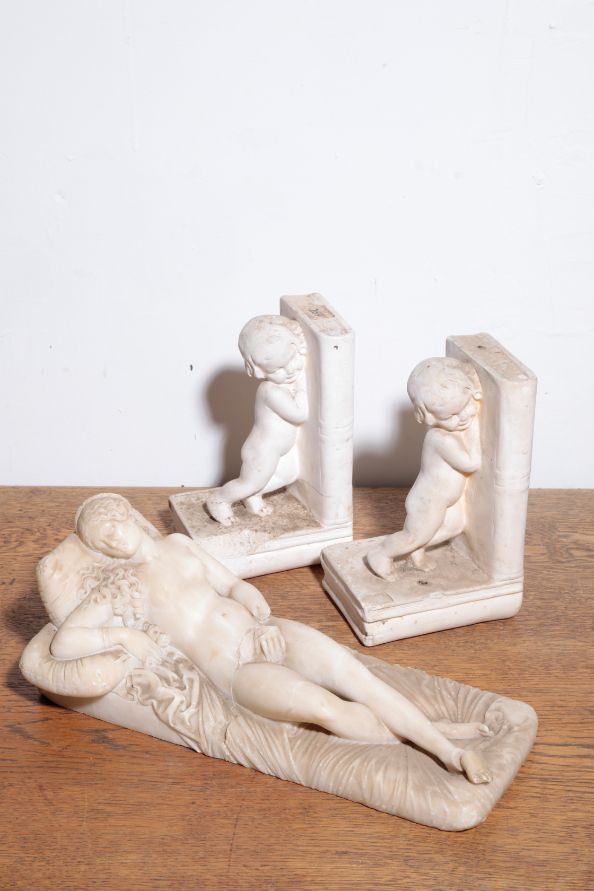 AN ITALIAN SCULPTED WHITE MARBLE MODEL OF A RECLINING NUDE,