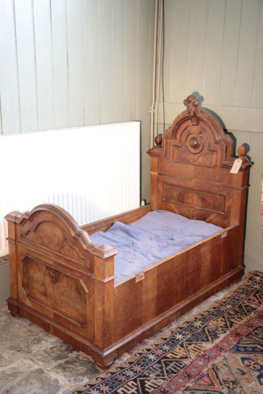 AN ITALIAN WALNUT COT,