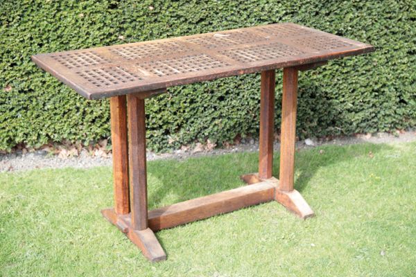 AN OAK CAFE TABLE, REPUTEDLY FROM THE THAMES TERRACE OF THE PALACE OF WESTMINSTER,