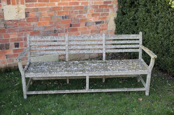 A TEAK GARDEN BENCH, AFTER A DESIGN BY GORDON RUSSELL,