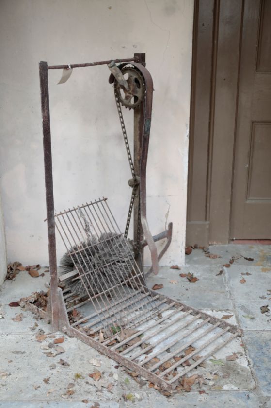 A WROUGHT IRON COUNTRY HOUSE MECHANICAL BOOT CLEANER,