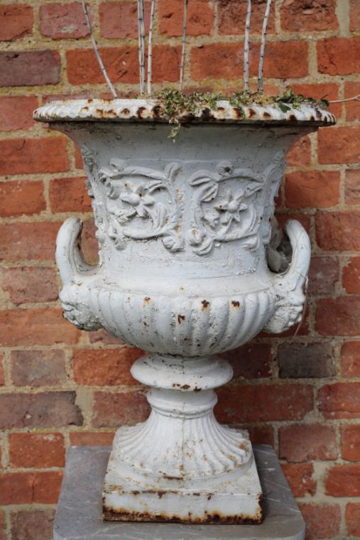 A VICTORIAN PAINTED CAST IRON TWIN HANDLED GARDEN URN,