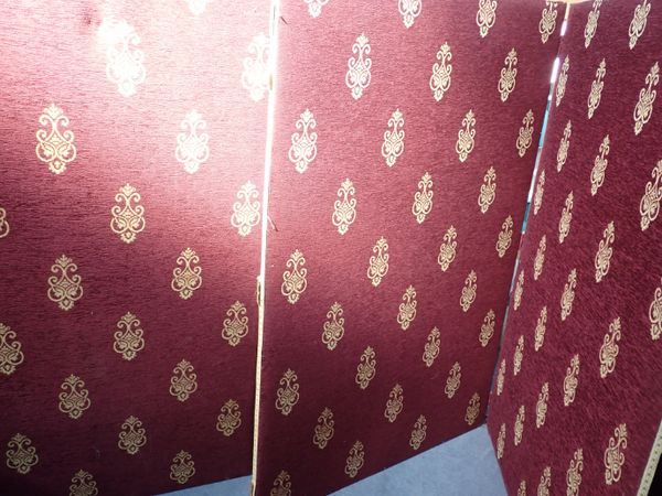 A THREE-PANEL UPHOLSTERED FOLDING SCREEN