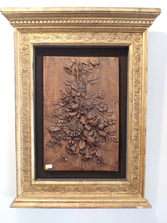 A WALNUT PANEL, CARVED WITH A BUNCH OF FLOWERS