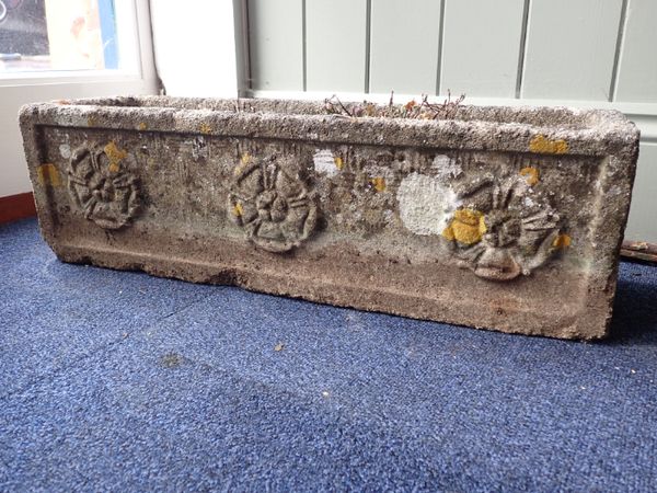 A WEATHERED RECONSTITUTED STONE GARDEN PLANTER