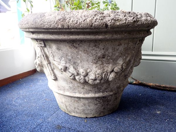 A WEATHERED RECONSTITUTED STONE GARDEN PLANTER