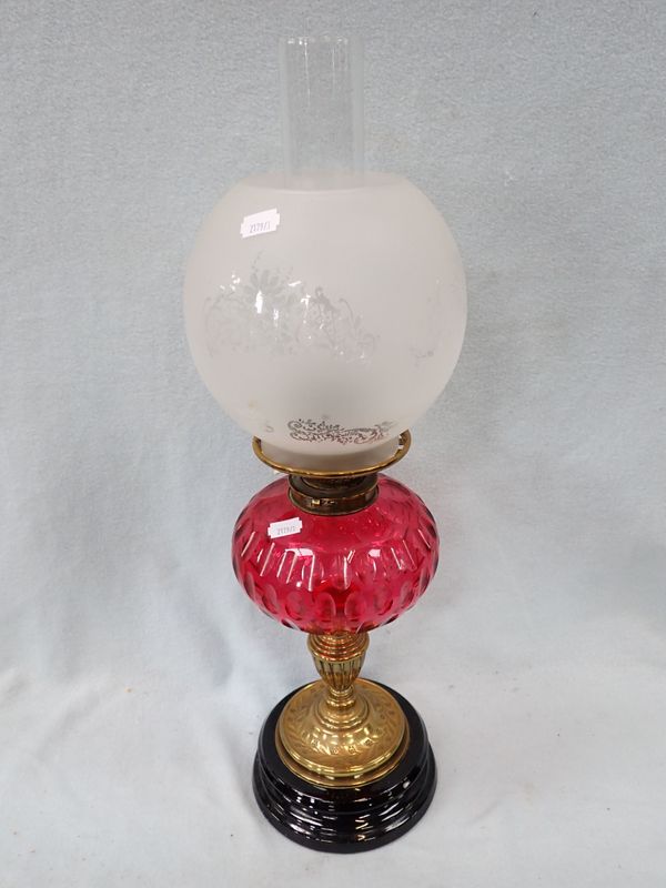 A VICTORIAN OIL LAMP WITH CRANBERRY GLASS FONT