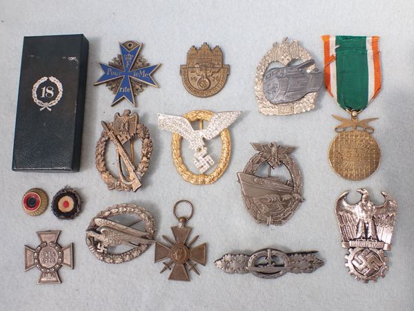 A COLLECTION OF NAZI STYLE BADGES