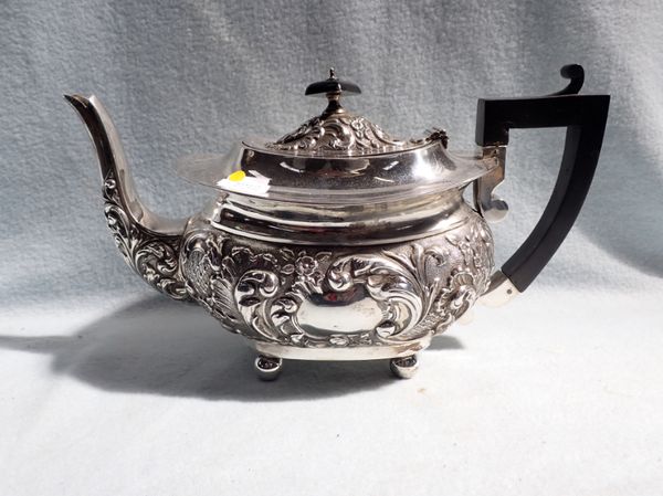 A SILVER TEAPOT WITH ROCOCO DECORATION